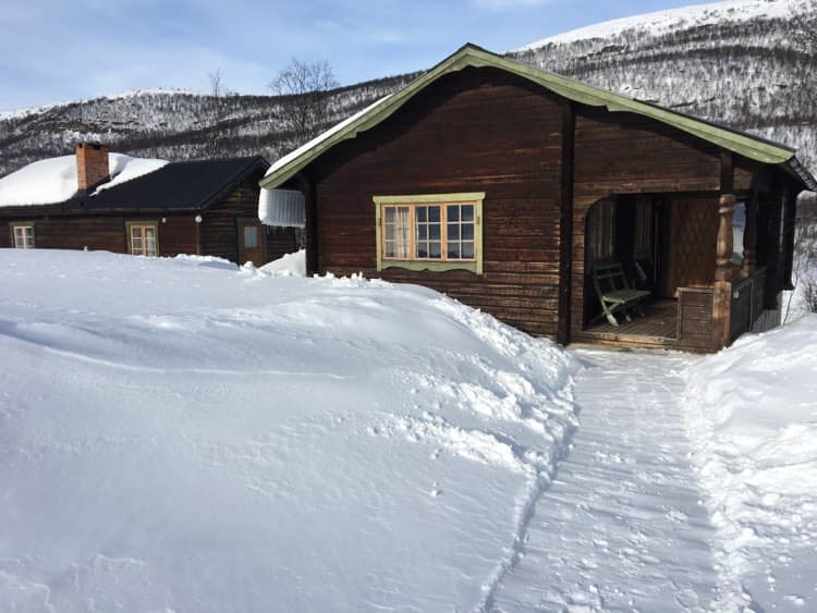 The small and big cabin covered in snow